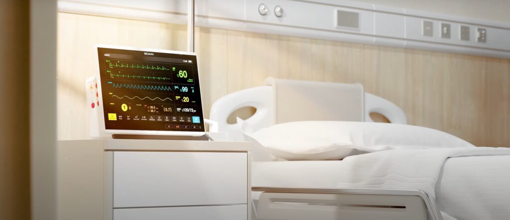 Monitor edan ao lado de cama hospitalar